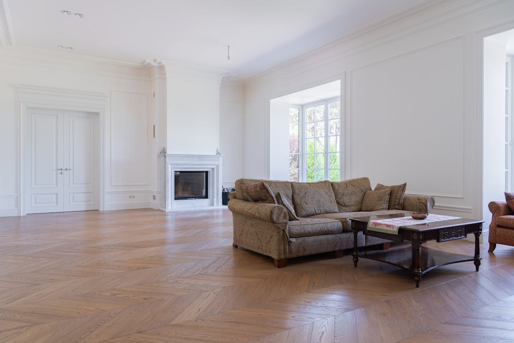 Beautiful spacious living room featuring elegant modern furniture and hardwood floors.